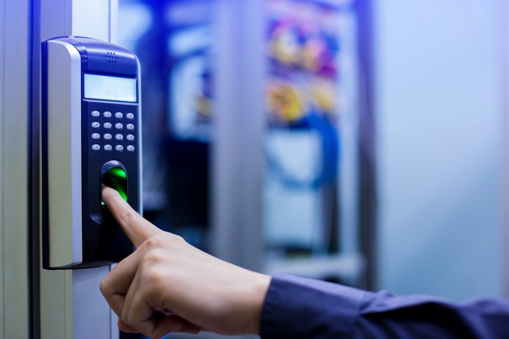 Person scanning fingerprint on biometric access control system 1024x683